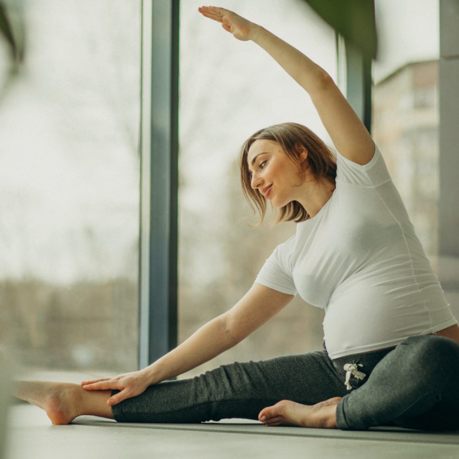 Young pregnant woman practicing yoga at home Young pregnant woman practicing yoga at home